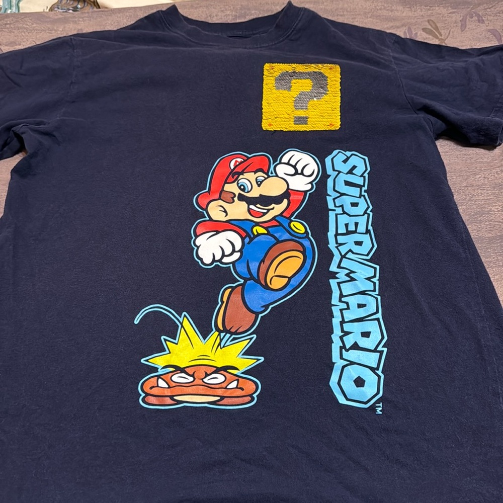 Boy’s Super Mario Brothers tee shirt in navy blue with flippy design. XL. Used.
